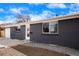 A side view of the gray brick home and the home's landscaping at 9101 Clarkson St, Thornton, CO 80229