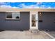 Close up of the front door and brick of the gray home at 9101 Clarkson St, Thornton, CO 80229