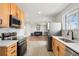 Open kitchen with a view into the cozy living room, stainless steel appliances, and ample counter space, ideal for entertaining at 9101 Clarkson St, Thornton, CO 80229