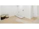 Bright laundry room with tiled floor drain, neutral carpet, and ample space for sorting and cleaning clothes at 9101 Clarkson St, Thornton, CO 80229