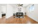 Bright living room with hardwood floors, modern fan, and large floral print at 9101 Clarkson St, Thornton, CO 80229