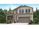 Charming two-story home with stone accents, manicured lawn, and an attached two-car garage at 28645 E 6Th Pl, Watkins, CO 80137