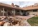 Landscaped backyard with a water feature, green grass, covered patio and mature trees at 2250 N Monaco Pkwy, Denver, CO 80207