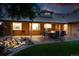 Spacious backyard featuring a patio, outdoor seating, and lush green lawn with a fountain at 2250 N Monaco Pkwy, Denver, CO 80207