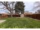 Spacious backyard with green grass, mature trees, and a shed at 2250 N Monaco Pkwy, Denver, CO 80207