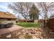 Beautifully landscaped backyard with a water feature, lush grass, dining set and mature trees at 2250 N Monaco Pkwy, Denver, CO 80207