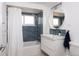 Bright bathroom featuring blue subway tile and a modern vanity at 2250 N Monaco Pkwy, Denver, CO 80207