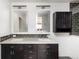 Elegant bathroom features a double sink vanity, granite countertops, and modern fixtures with beautiful mosaic tile details at 2250 N Monaco Pkwy, Denver, CO 80207