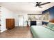 Spacious bedroom with hardwood floors, ceiling fan, large window, and ample closet space, enhanced by modern furnishings at 2250 N Monaco Pkwy, Denver, CO 80207