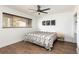 Bright bedroom features a stylish ceiling fan, modern art, and a large window at 2250 N Monaco Pkwy, Denver, CO 80207