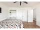 Cozy bedroom features a ceiling fan, built-in shelves, and natural light at 2250 N Monaco Pkwy, Denver, CO 80207