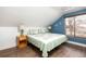 Comfortable bedroom with hardwood floors, window, and a cozy quilt at 2250 N Monaco Pkwy, Denver, CO 80207