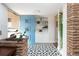 Bright entryway featuring unique tile, blue door, and convenient shelving at 2250 N Monaco Pkwy, Denver, CO 80207