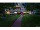 Charming single-story home with mature trees, lush green lawn and inviting walkway at 2250 N Monaco Pkwy, Denver, CO 80207