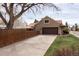Exterior view of a single-Gathering home with a long driveway and mature landscaping at 2250 N Monaco Pkwy, Denver, CO 80207