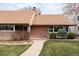 Inviting front porch with chairs and plants, perfect for relaxing outdoors at 2250 N Monaco Pkwy, Denver, CO 80207