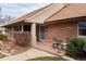 Close-up of front porch with seating area and brick accents at 2250 N Monaco Pkwy, Denver, CO 80207