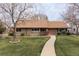 Charming single-story home with a well-manicured lawn and inviting walkway at 2250 N Monaco Pkwy, Denver, CO 80207