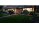 Well-manicured front yard with landscape lighting and green grass, leading to the home's entrance at 2250 N Monaco Pkwy, Denver, CO 80207