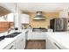 Charming kitchen with modern appliances, ample counter space, decorative backsplash, and a stainless steel range hood at 2250 N Monaco Pkwy, Denver, CO 80207
