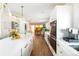 Open kitchen featuring white cabinets, modern appliances, and a large island, seamlessly connects to other living spaces at 2250 N Monaco Pkwy, Denver, CO 80207
