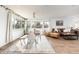Bright and airy living room with large windows, hardwood floors, and modern furniture at 2250 N Monaco Pkwy, Denver, CO 80207
