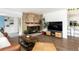 Comfortable living area featuring a stone fireplace and open layout with views of the dining area at 2250 N Monaco Pkwy, Denver, CO 80207