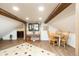 A cozy living area includes a dining table, brick accent wall, and hardwood floors at 2250 N Monaco Pkwy, Denver, CO 80207