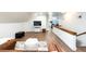 Spacious living room with wood floors, large sectional, and mounted TV at 2250 N Monaco Pkwy, Denver, CO 80207