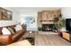 Warm and inviting living room with a brick fireplace and an open view to the stylish foyer at 2250 N Monaco Pkwy, Denver, CO 80207