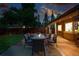 Outdoor patio with a gas fire pit, dining table, and well-maintained backyard at 2250 N Monaco Pkwy, Denver, CO 80207