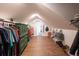 A generously sized walk-in closet with built in shelving, wooden floors and ample hanging space at 2250 N Monaco Pkwy, Denver, CO 80207