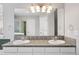 Bathroom with double sink vanity, tiled countertop, large mirror, and tiled backsplash at 20481 E Mansfield Pl, Aurora, CO 80013