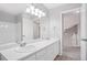 Bathroom featuring double sinks, a large mirror, and stairway access to the home's upper level at 20481 E Mansfield Pl, Aurora, CO 80013