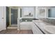 Well-lit bathroom featuring a shower, bathtub, and double sink vanity at 20481 E Mansfield Pl, Aurora, CO 80013