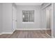 Well-lit bedroom with light-colored walls, modern floors, and closet with sliding mirror doors at 20481 E Mansfield Pl, Aurora, CO 80013