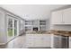 Open kitchen with granite countertops, modern appliances, and fireplace view at 20481 E Mansfield Pl, Aurora, CO 80013