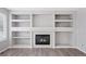 Cozy living room features built-in shelving and a fireplace at 20481 E Mansfield Pl, Aurora, CO 80013