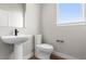 Simple half bath with white sink, toilet and window, offering essential functionality at 14265 Currant St, Broomfield, CO 80020