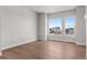 Bright, empty bedroom with wood floors and ample natural light from large windows at 14265 Currant St, Broomfield, CO 80020