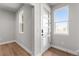 Bright entryway featuring wood-look floors, white trim, and a glass-paneled door at 14265 Currant St, Broomfield, CO 80020