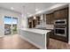 Bright kitchen with island, stainless steel appliances, and sliding glass doors at 14265 Currant St, Broomfield, CO 80020