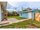 Cozy backyard featuring a storage building, lawn, and wooden fence at 5001 W Nevada Pl, Denver, CO 80219