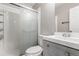 Bathroom featuring a shower with sliding glass doors and a gray vanity at 5001 W Nevada Pl, Denver, CO 80219