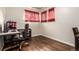 Bedroom with wooden floors, large desk and red curtains at 5001 W Nevada Pl, Denver, CO 80219