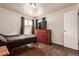Bedroom with hardwood floors, a dresser, and natural light from the windows at 5001 W Nevada Pl, Denver, CO 80219
