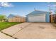 A spacious garage with a white door stands near the newly installed wooden fence and driveway at 5001 W Nevada Pl, Denver, CO 80219