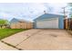 A spacious garage with a white door stands near the newly installed wooden fence and driveway at 5001 W Nevada Pl, Denver, CO 80219