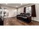 Living room with hardwood floors, a large window, and a modern leather sofa at 5001 W Nevada Pl, Denver, CO 80219