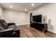 Relaxing living room with hardwood flooring, entertainment center, and a plush leather sofa at 5001 W Nevada Pl, Denver, CO 80219